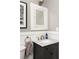 Bathroom vanity with marble countertop, dark cabinets and traditional fixtures at 3120 Church St, Atlanta, GA 30344