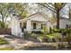 Quaint one-story home with white exterior, well-kept yard, and driveway to the left side at 3120 Church St, Atlanta, GA 30344
