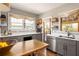 Modern kitchen with gray cabinets, stone countertops, stainless appliances and access to the backyard at 3120 Church St, Atlanta, GA 30344