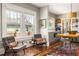 Eat-in kitchen with stainless appliances, island table, and large windows with view to the neighborhood at 3120 Church St, Atlanta, GA 30344