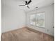 This carpeted bedroom features a window and a modern ceiling fan at 510 Towneside Ln, Marietta, GA 30064