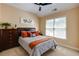 Bedroom with light beige walls, light carpet, a window, ceiling fan and furniture at 510 Towneside Ln, Marietta, GA 30064
