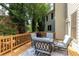 Outdoor furniture with custom rug on wooden deck of house with beige siding and green trees at 510 Towneside Ln, Marietta, GA 30064