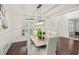 This dining room features a modern light fixture, large window, and wainscoting at 510 Towneside Ln, Marietta, GA 30064