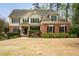 Beautiful two-story home with a brick and siding exterior, black shutters, and mature landscaping at 510 Towneside Ln, Marietta, GA 30064