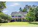 Traditional two-story home with green lawn and lush landscaping in a suburban neighborhood at 510 Towneside Ln, Marietta, GA 30064