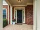 Inviting front entrance showcasing a black door, brick columns, and meticulously maintained landscaping at 510 Towneside Ln, Marietta, GA 30064