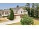 Side view of the home showcasing the brick accents and two-car garage with ample driveway space at 510 Towneside Ln, Marietta, GA 30064