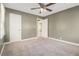 Spacious bedroom featuring neutral carpet, a ceiling fan, and freshly painted walls at 1958 Long Dr, Decatur, GA 30032