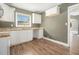 Well-lit kitchen with white cabinets, light countertops and updated fixtures at 1958 Long Dr, Decatur, GA 30032
