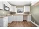 Updated kitchen featuring modern white cabinets, light countertops and updated fixtures at 1958 Long Dr, Decatur, GA 30032
