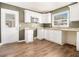Bright kitchen featuring modern white cabinets, laminate counters, and a stainless steel microwave at 1958 Long Dr, Decatur, GA 30032
