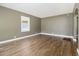 Spacious living room with hardwood floors, neutral paint, and natural light from the window at 1958 Long Dr, Decatur, GA 30032