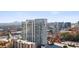 Aerial view of modern high-rise apartment building in a vibrant urban setting at 3325 Piedmont Ne Rd # 2104, Atlanta, GA 30305