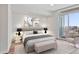 Bright main bedroom features hardwood floors, balcony access, and city views at 3325 Piedmont Ne Rd # 2104, Atlanta, GA 30305