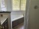 Bright bathroom featuring a jacuzzi tub and a shower with a shower curtain at 5167 Manitu Sw Ct, Lilburn, GA 30047