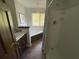 Bathroom featuring a tiled floor, a jacuzzi tub and a shower with a shower curtain at 5167 Manitu Sw Ct, Lilburn, GA 30047