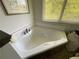 Jacuzzi tub with jets and tile surround, providing a luxurious soaking experience at 5167 Manitu Sw Ct, Lilburn, GA 30047