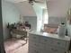 Cozy bedroom features a soft color palette, a desk, a dresser, and natural light at 5167 Manitu Sw Ct, Lilburn, GA 30047