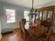 Classic dining room featuring a chandelier, hardwood floors, and traditional furniture at 5167 Manitu Sw Ct, Lilburn, GA 30047