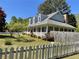 Inviting home with a cozy front porch, dormer windows, a brick chimney, complemented by a well-manicured lawn at 5167 Manitu Sw Ct, Lilburn, GA 30047