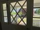 View through the decorative glass front door onto the well-maintained front yard at 5167 Manitu Sw Ct, Lilburn, GA 30047