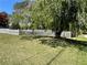 Grassy lawn and large shade tree in the front yard of a charming house at 5167 Manitu Sw Ct, Lilburn, GA 30047