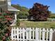 Charming home with manicured lawn, white picket fence, and mature trees at 5167 Manitu Sw Ct, Lilburn, GA 30047