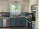 Charming kitchen featuring stainless steel appliances, granite countertops, and stylish painted cabinets at 5167 Manitu Sw Ct, Lilburn, GA 30047