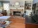 Bright living room boasts a brick fireplace, hardwood floors, and built-in shelving for a cozy and inviting atmosphere at 5167 Manitu Sw Ct, Lilburn, GA 30047