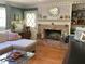 Inviting living room features a brick fireplace, classic hardwood floors, and built-in shelves at 5167 Manitu Sw Ct, Lilburn, GA 30047