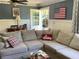 Comfortable living room with large sectional couch, view of back yard slide, and decor at 5167 Manitu Sw Ct, Lilburn, GA 30047