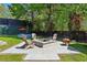 Inviting backyard with fire pit, Adirondack chairs, stock tank pool, and lush green lawn at 727 Channing Nw Dr, Atlanta, GA 30318