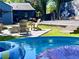 Backyard with inviting firepit, lounge chairs, stock tank pool, and mural creating a fun and relaxing oasis at 727 Channing Nw Dr, Atlanta, GA 30318