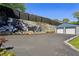 Long driveway leading to a two car garage with a mural on the retaining wall at 727 Channing Nw Dr, Atlanta, GA 30318