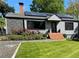 Updated home with fresh landscaping, solar panels and brick entry at 727 Channing Nw Dr, Atlanta, GA 30318