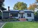 View of the exterior of a cozy home with solar panels and a lush green lawn at 727 Channing Nw Dr, Atlanta, GA 30318