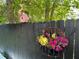 Charming fence with pink flamingo birdhouse and hanging flower basket adding vibrant color at 727 Channing Nw Dr, Atlanta, GA 30318
