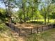 Modern playground with swings, slides, and climbing structures in fenced area at 727 Channing Nw Dr, Atlanta, GA 30318