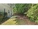 Expansive backyard features a small patio with lush greenery and a wooded area, creating a private retreat at 1715 Crestwell Ln, Grayson, GA 30017
