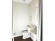 Compact half-bathroom with a pedestal sink and hardwood floors at 1715 Crestwell Ln, Grayson, GA 30017