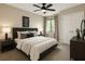 Relaxing bedroom features a ceiling fan, a bed with pillows, and double door closet for optimal storage solutions at 1715 Crestwell Ln, Grayson, GA 30017