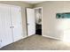 Bedroom featuring neutral carpet, white closet doors, and painted walls at 1715 Crestwell Ln, Grayson, GA 30017