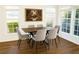 Dining room with wood floors, six chairs, and lots of natural light at 1715 Crestwell Ln, Grayson, GA 30017