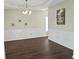 Dining room with dark wood floors, tray ceiling, chandelier, and white wainscoting at 1715 Crestwell Ln, Grayson, GA 30017