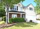 Well-maintained home features neutral siding, brick accents, black shutters and a two-car garage at 1715 Crestwell Ln, Grayson, GA 30017
