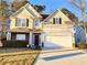 Charming two-story home with a well-manicured lawn and attached two-car garage at 1715 Crestwell Ln, Grayson, GA 30017