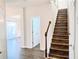Welcoming foyer with beautiful hardwood floors and staircase leading to the upper level at 1715 Crestwell Ln, Grayson, GA 30017
