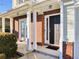 Inviting front porch features white columns, brick accents and a stylish front door at 1715 Crestwell Ln, Grayson, GA 30017
