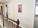 Upstairs hallway featuring wood floors, white walls, and white doors to rooms at 1715 Crestwell Ln, Grayson, GA 30017
